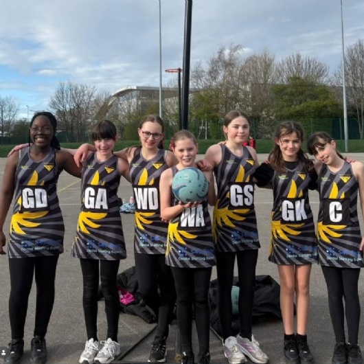 girls netball team pose for a photo